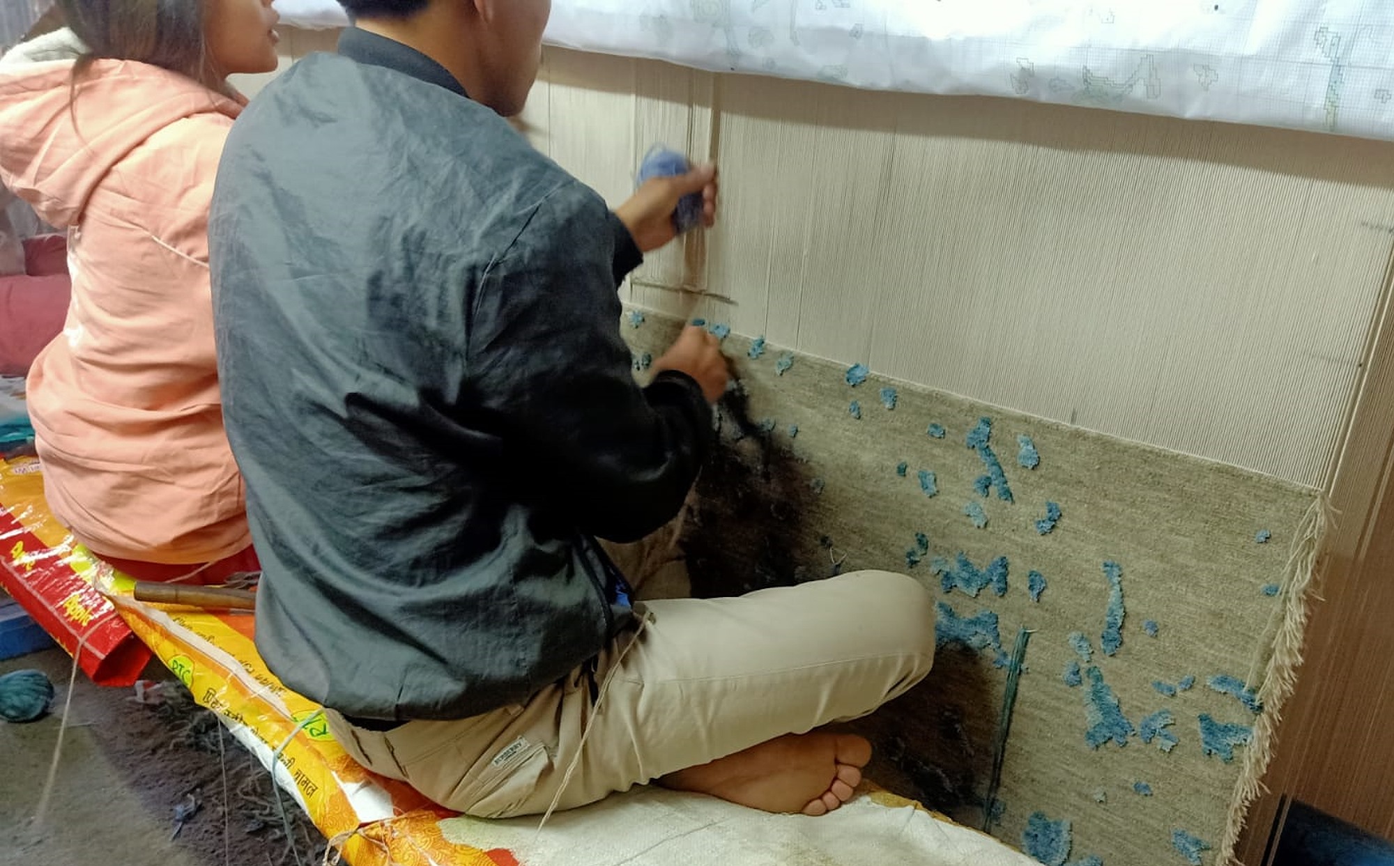 Traditional rug weaving under fair conditions