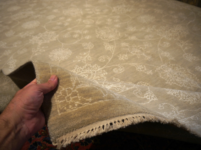 This original hand-knotted Agra Style Rug measures 9 x 12 ft and goes well with interior design styles. The pale and faded color gives it a cool look. 15653