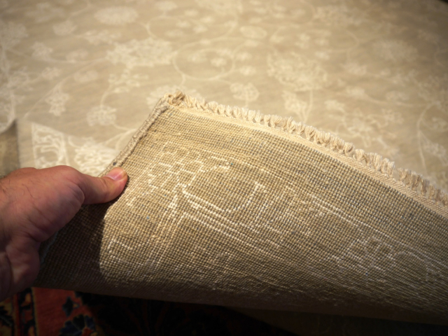 This original hand-knotted Agra Style Rug measures 9 x 12 ft and goes well with interior design styles. The pale and faded color gives it a cool look. 15653